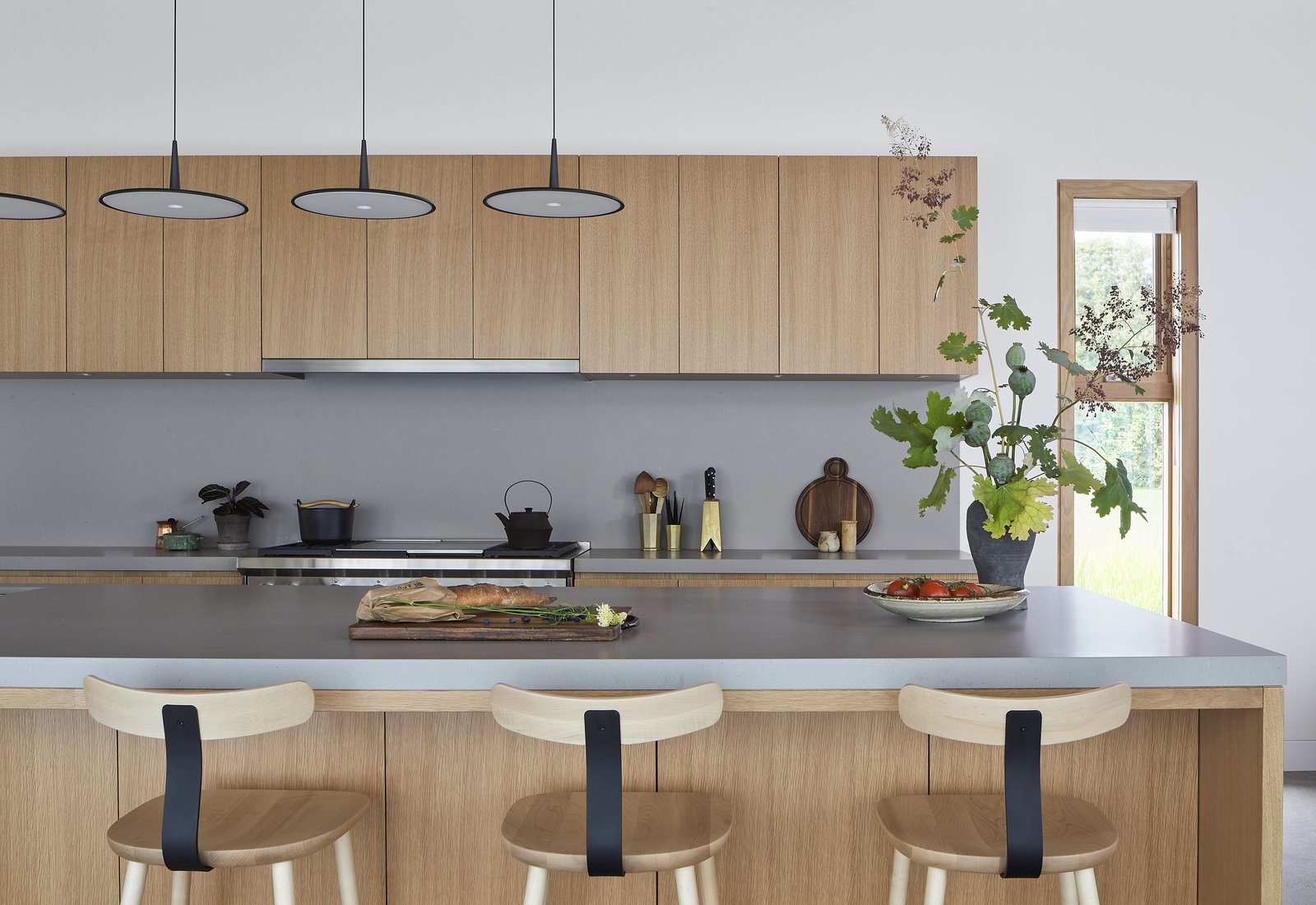caesarstone-countertops-were-used-in-the-kitchen-skan-by-vibia-pendants-hang-above-the-island.jpg